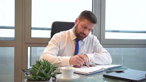 Businessman working with documents in office, portrait, dolly shot, backwards Stock Footage 72500541