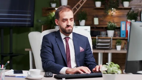 Businessman working extra hours in the week end looks at the time Stock Footage 109607440