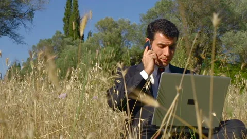 Businessman working in the fields Stockbeeldmateriaal 210448570
