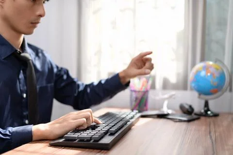 Businessman working in front of a notebook computer at a desk Stock Photos