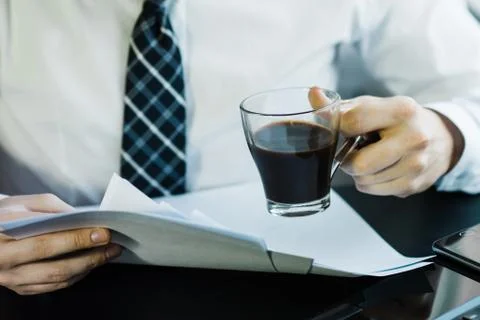 Businessman working with generic design notebook. Holding smartphone in hands 스톡 사진