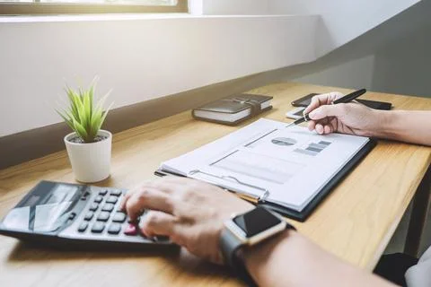 Businessman working on a graph document financial report and analysis calcu.. Stock Photos