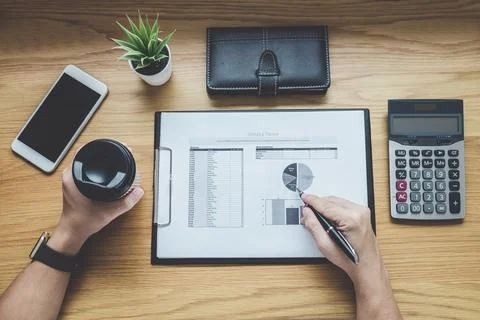 Businessman working on a graph document financial report and analysis calcu.. Stock Photos