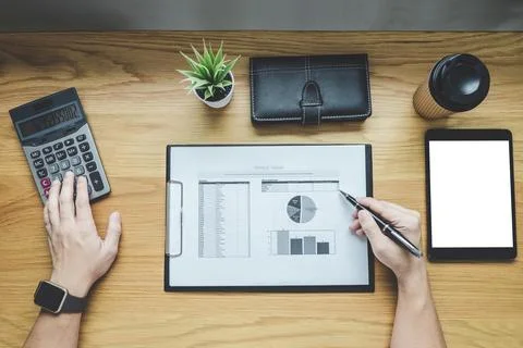 Businessman working on a graph document financial report and analysis calcu.. Stock Photos