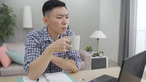 Businessman working from home is drinking Video stock 157725560