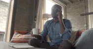 Businessman Working From Home Talking On Telephone And Drinking Coffee Stock Footage
