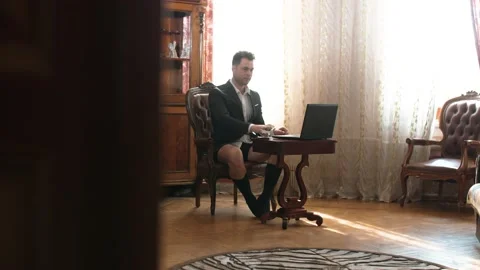 Businessman working at home without pants Stock Footage 132609989