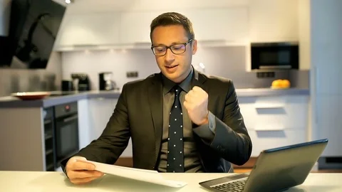 Businessman working in the kitchen and receiving good news Stock-Footage 73000759