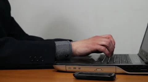 Businessman working on laptop and using smartphone Stock Footage 11067934