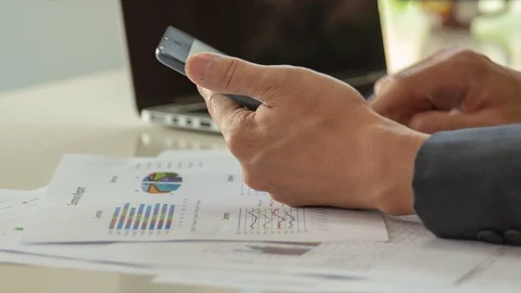 Businessman working with laptop and using smart phone, closedup Stock Footage 98561550
