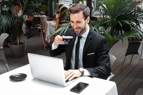 Businessman working on laptop in cafe wih a coffee Stock Photos