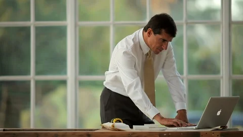 Businessman working on a laptop computer on a construction site. Stock-Footage 88342191