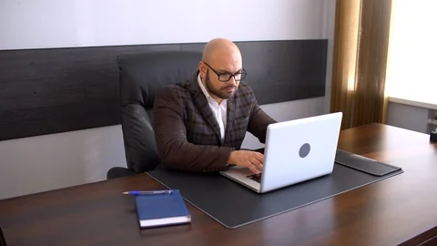 Businessman working on laptop computer in the office Stock Footage 86656545
