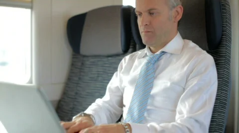 Businessman working with laptop computer on train Stock Footage 706229