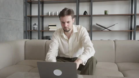 Businessman Working On Laptop, Deep In Thought, Strategising To Solve Challenge Stock Footage 303086375
