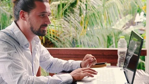 Businessman working with laptop while reading a planning book and thinking idea Stock Footage 72948335