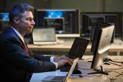 Businessman Working On Multiple Computers Foto stock