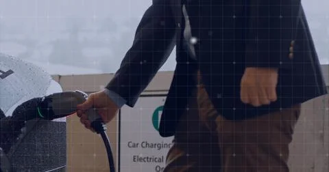 Businessman working in office with data processing image over grid background 写真素材