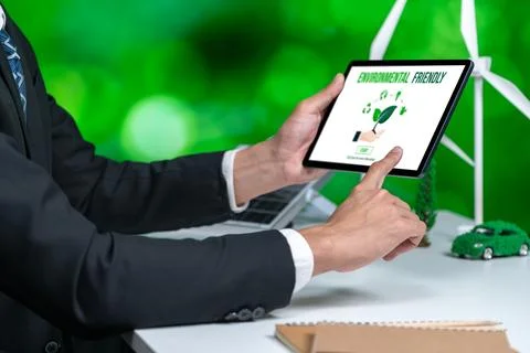 Businessman working in office developing plan on alternative energy. Gyre Stock Photos
