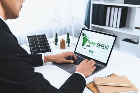 Businessman working in office developing plan on alternative energy. Gyre Stock Photos