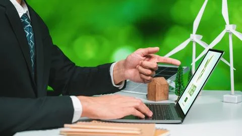 Businessman working in office developing plan on alternative energy. Gyre Stock Photos