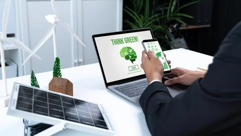 Businessman working in office developing plan on alternative energy. Gyre Stock Photos