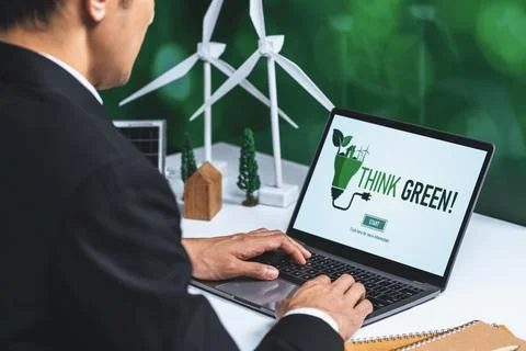 Businessman working in office developing plan on alternative energy. Gyre Stock Photos
