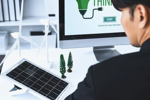 Businessman working in office developing plan on alternative energy. Gyre Stock Photos