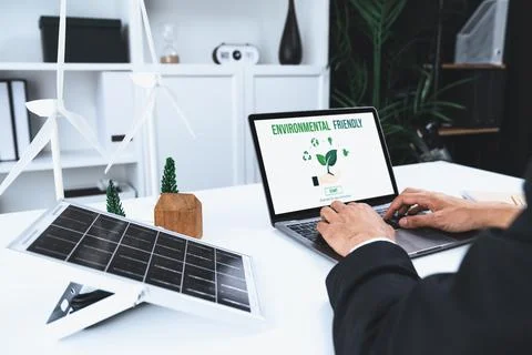 Businessman working in office developing plan on alternative energy. Gyre Stock Photos