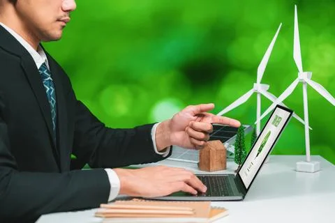 Businessman working in office developing plan on alternative energy. Gyre Foto stock