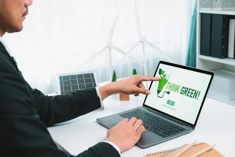 Businessman working in office developing plan on alternative energy. Gyre Stock Photos
