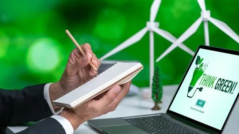 Businessman working in office developing plan on alternative energy. Gyre Stock Photos