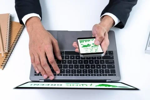 Businessman working in office developing plan on alternative energy. Gyre Stock Photos