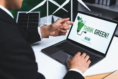 Businessman working in office developing plan on alternative energy. Gyre Stock Photos