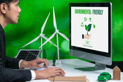 Businessman working in office developing plan on alternative energy. Gyre Stock Photos