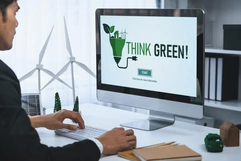 Businessman working in office developing plan on alternative energy. Gyre Stock Photos