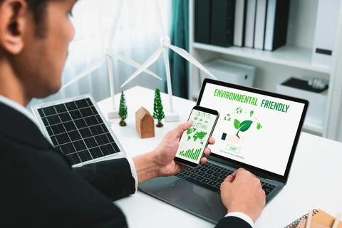 Businessman working in office developing plan on alternative energy. Gyre Stock Photos