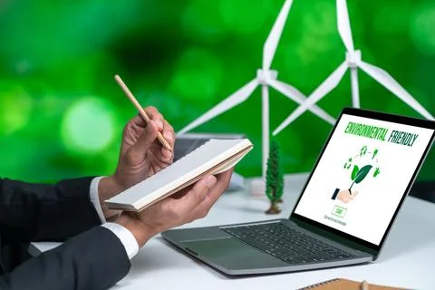 Businessman working in office developing plan on alternative energy. Gyre Stock Photos