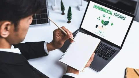 Businessman working in office developing plan on alternative energy. Gyre Stock Photos