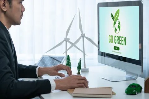 Businessman working in office developing plan on alternative energy. Gyre Stock Photos