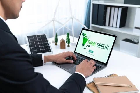 Businessman working in office developing plan on alternative energy. Gyre Stock Photos