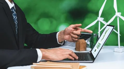 Businessman working in office developing plan on alternative energy. Gyre Stock Photos