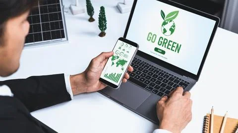 Businessman working in office developing plan on alternative energy. Gyre Stock Photos