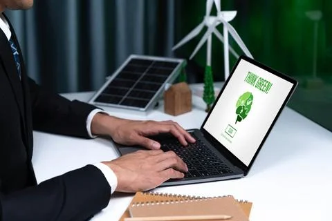 Businessman working in office developing plan on alternative energy. Gyre Stock Photos