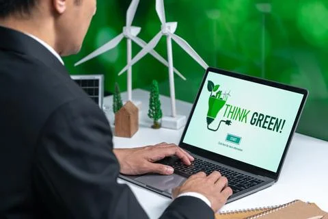 Businessman working in office developing plan on alternative energy. Gyre Stock Photos