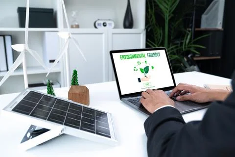 Businessman working in office developing plan on alternative energy. Gyre Stock Photos