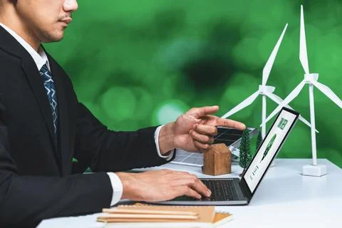 Businessman working in office developing plan on alternative energy. Gyre Stock Photos