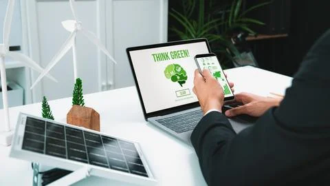 Businessman working in office developing plan on alternative energy. Gyre Stock Photos