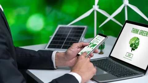 Businessman working in office developing plan on alternative energy. Gyre Stock Photos