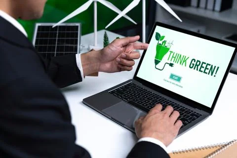 Businessman working in office developing plan on alternative energy. Gyre Stock Photos